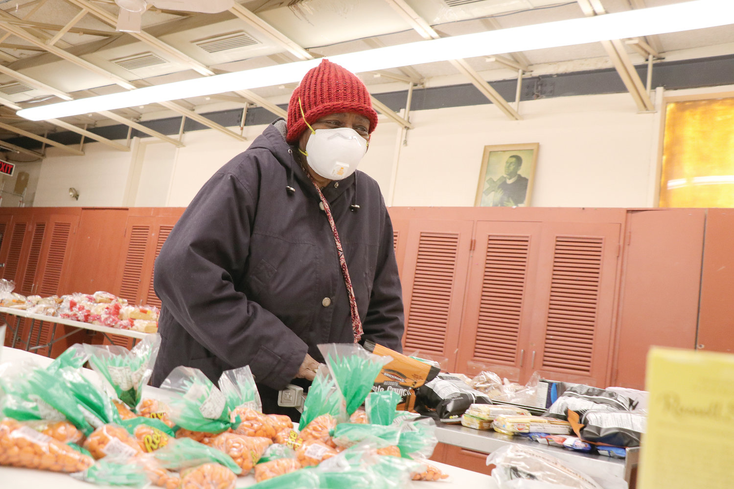 Gladys Willis, 88, shops among the donated food items available at the diocesan St. Martin de Porres Center, which has been transformed into a makeshift food pantry during the pandemic.